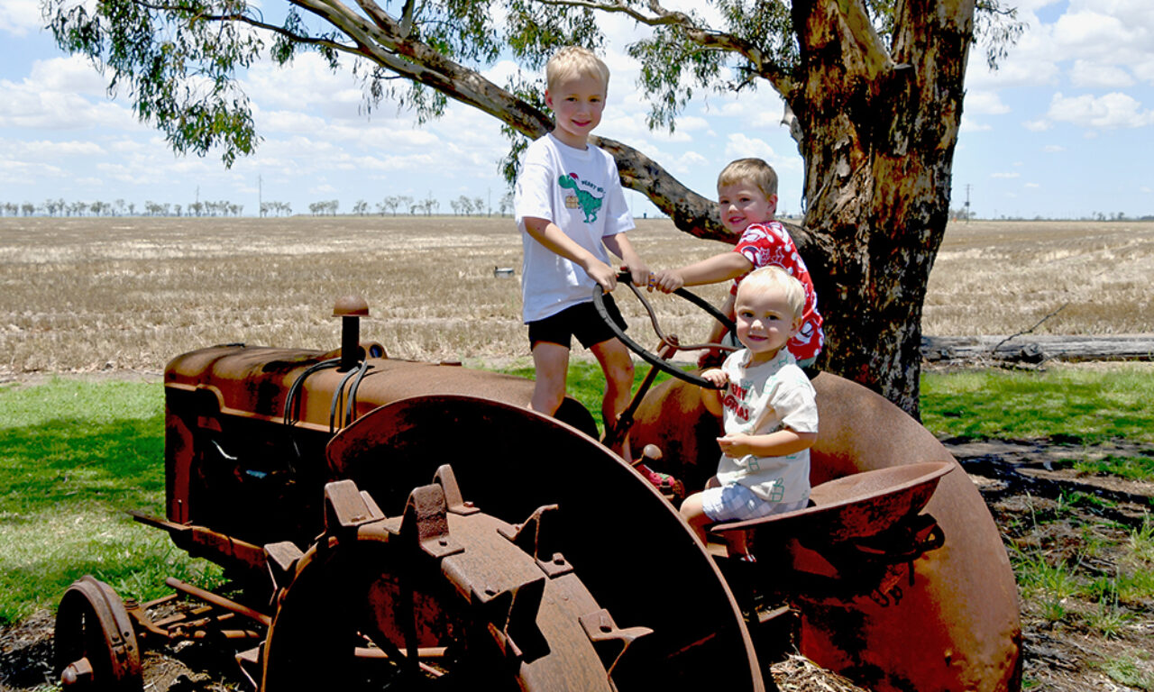 The Walton kids from Dalby on their Great-Grandfather's tractor, wearing Christmas clothing from Target and Big W